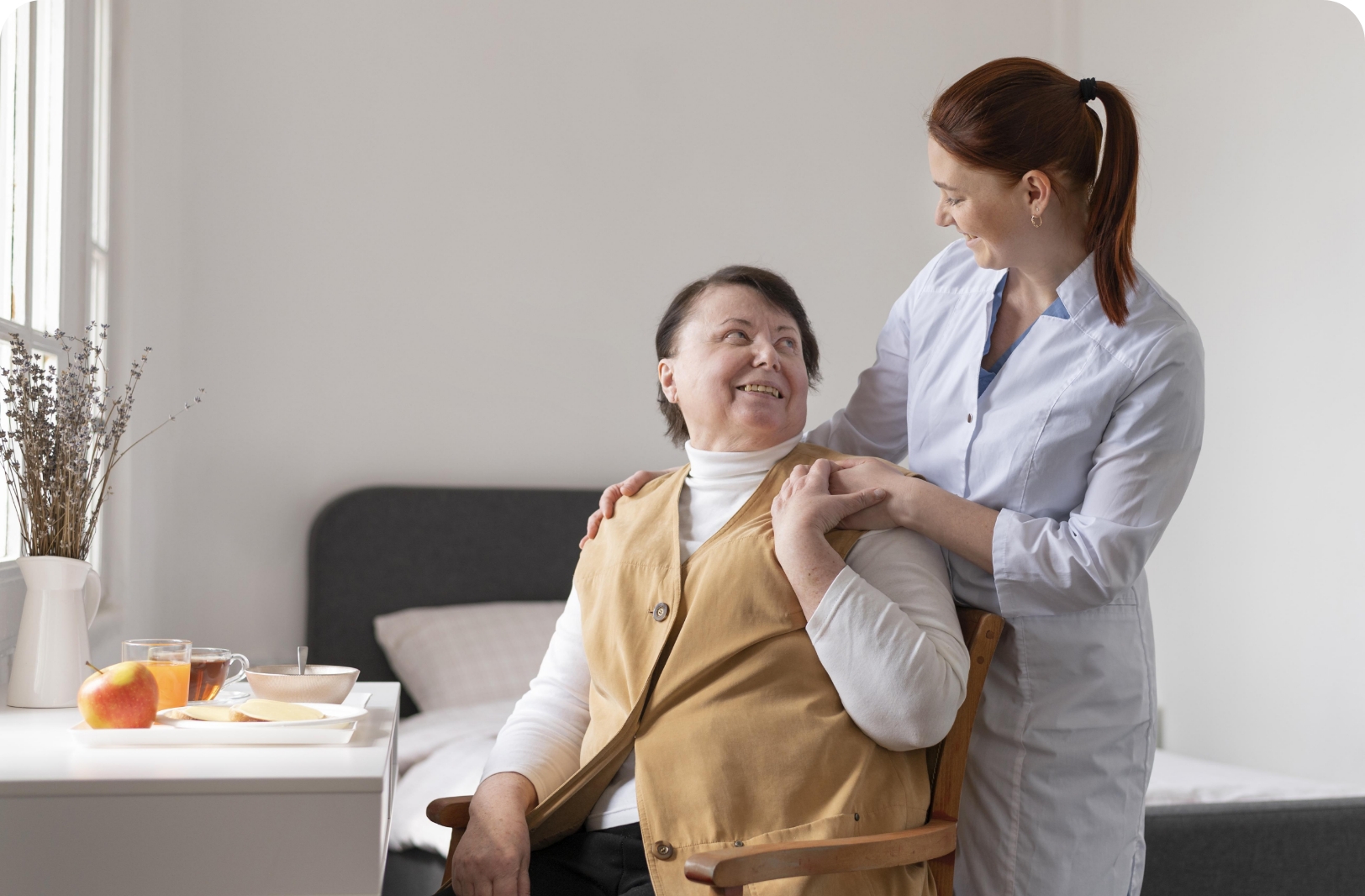 A caregiver assisting an elderly person.